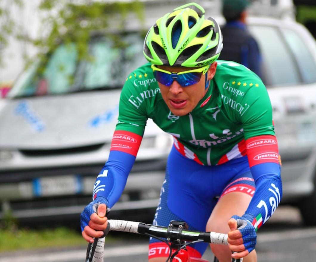 Racing cyclist, green jersey with red and white stripes, blue shorts and warm warmers, yellow helmet, Dan Pearson, Zalf, pic: Noemi Odessi