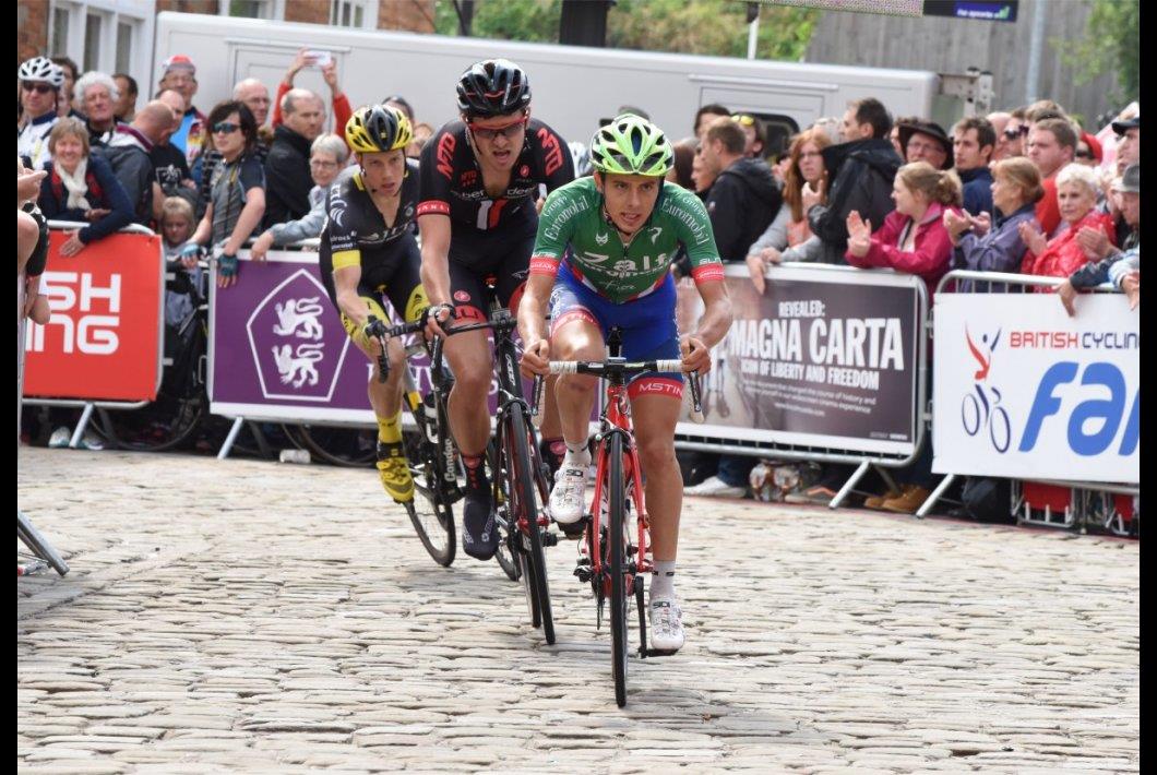Racing cyclists, three, pace line, cobbled road, corner, barriers, crowd, lead rider in green jersey and blue shorts, Dan Pearson, pic: Larry Hickmott